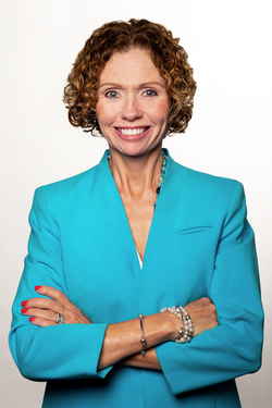 Head shot of Jenea Oliver smiling with her arms crossed. Jenea is the Senior Vice President and Chief Development Officer for the Philanthropy Department at Children's Mercy.