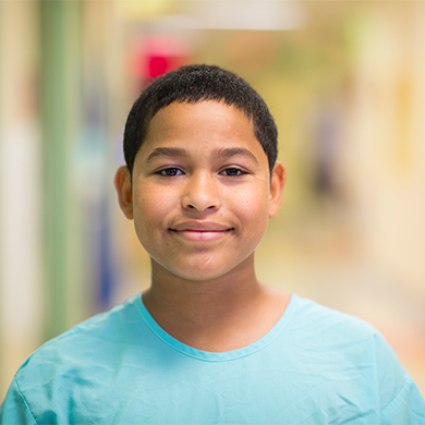 A teenage boy standing in one of the halls at Children's Mercy.