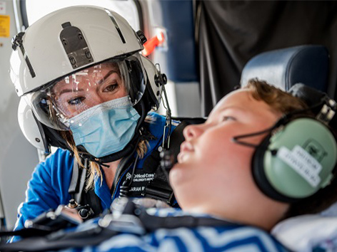 A member of the Children's Mercy Critical Care Transport team cares for a patient in the program's specially equipped helicopter.
