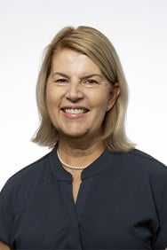Dr. Brenda Rogers smiling in front of a white background.