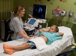 Children's Mercy technologist conducting an ultrasound on patient's stomach