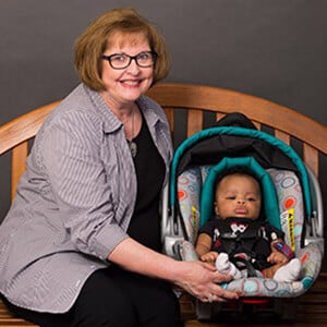 Mary Kinart with baby in a car seat