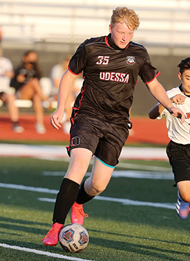 Alexander Armstrong playing soccer.