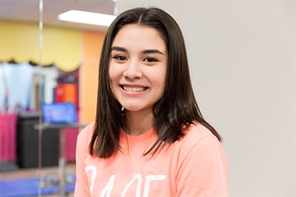 Sports Medicine patient, Gabby, smiling while at Sports Medicine Center. 