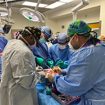 Four physicians operating on a dual transplant patient at Children's Mercy Kansas City.