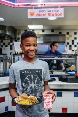 A child holds a plate of lunch at Children's Mercy Kids Eat Free program. 