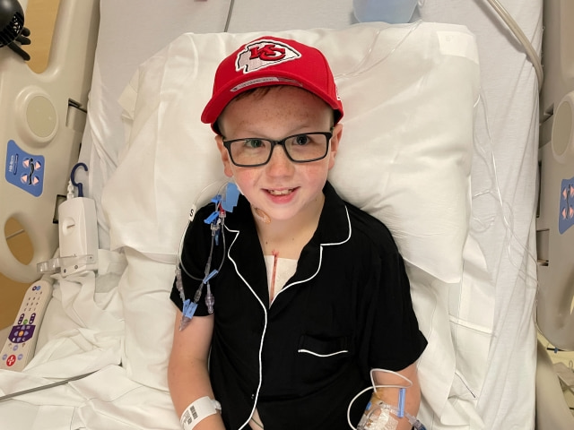 Zack, a Children's Mercy heart transplant patient, wears a Kansas City Chiefs hat in his hospital bed