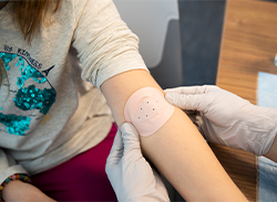 A Synera ® patch being applied to a child's arm.