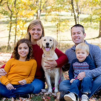 Joe Cummings with his wife, their daughter and son, and their dog.