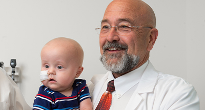 Dr. James Daniel with infant liver patient.