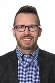 Dr. Jordan Jones smiling in front of a white background.