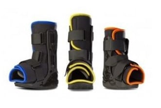 Photo of three CAM boots all lined in a different color: blue, yellow and orange.