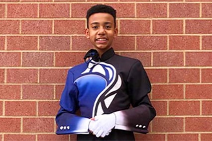 Jayden Johnson smiling in his band uniform.