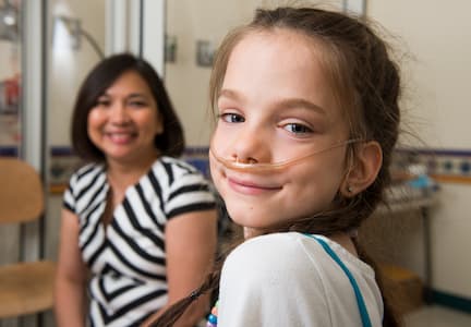 Estella in pulmonology clinic with nasal cannula oxygen mask on 