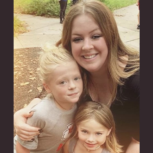 Maggie Van Meter smiling with her nephew and niece.