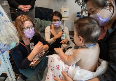 HPM Fellowship Faculty working with a patient and their mother at Children's Mercy.