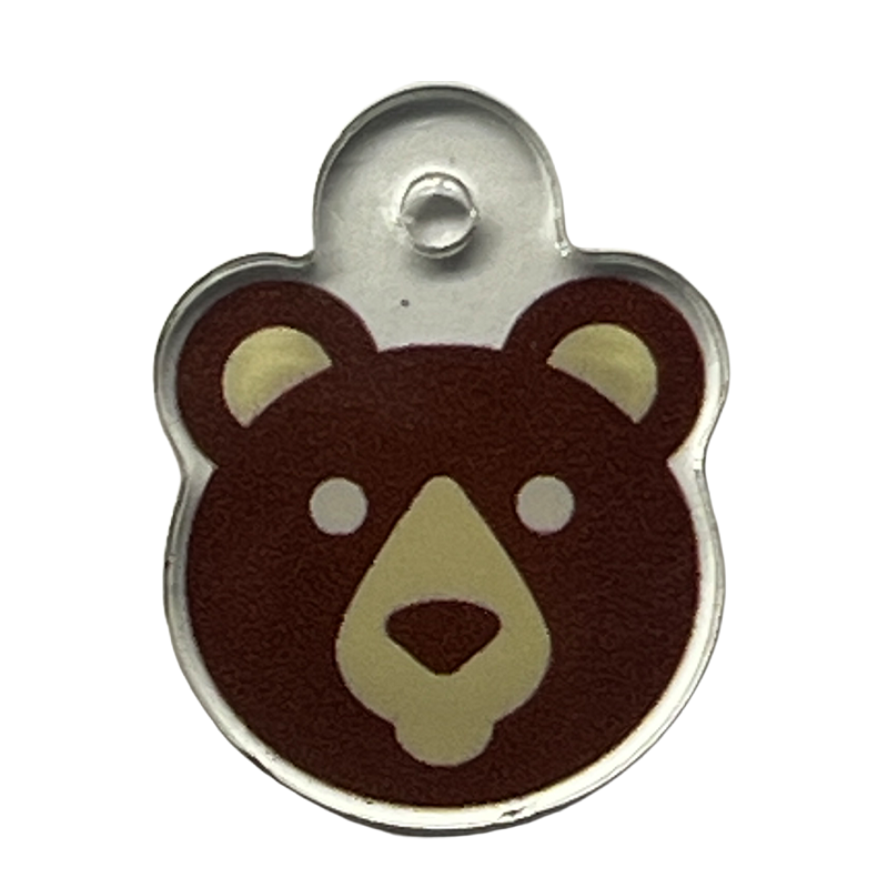 Acrylic charm with a brown teddy bear face icon.