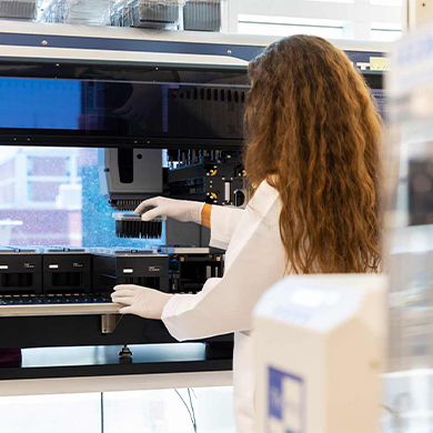 Image of a researcher in the Genomic Medicine Center working on genetic sequencing.
