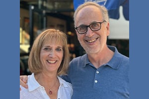 Barbara and Brad Warady standing outside smiling.