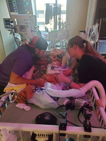 Wrenley in patient room with mom and dad