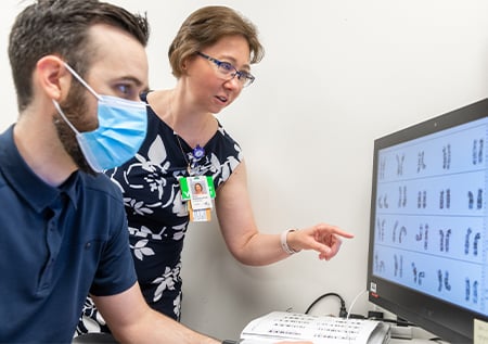 Fellow reviewing karyotype of a bone marrow sample with a Children's Mercy provider.