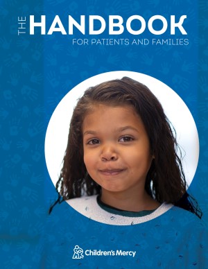 The Handbook cover, featuring a young girl in a hospital gown smiling.