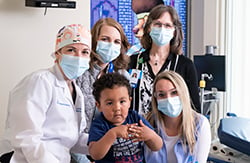 Taitum Ellis surrounded my Dr. Rentea and three other members of the Colorectal Care Center with mask covering their noses and mouths.