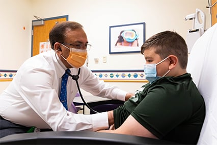Hayden Murnahan being examined at a Children's Mercy clinic by Dr. Chadha.