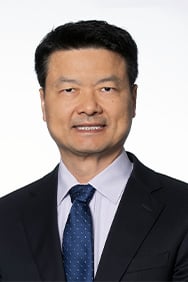Dr. Yong Li smiling in front of a white background.