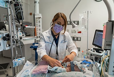 Dr. Ashley Daniel examining a patient in the CICU.