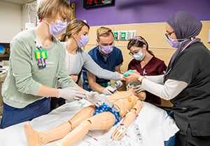Drs. Ashley Daniel, Nathan Lavoy and Jennifer Ruiz working with a multidisciplinary PICU team in a simulated resuscitation.