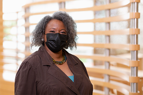 Melva Brownlee wearing a black face mask inside Children's Mercy Adele Hall chapel..