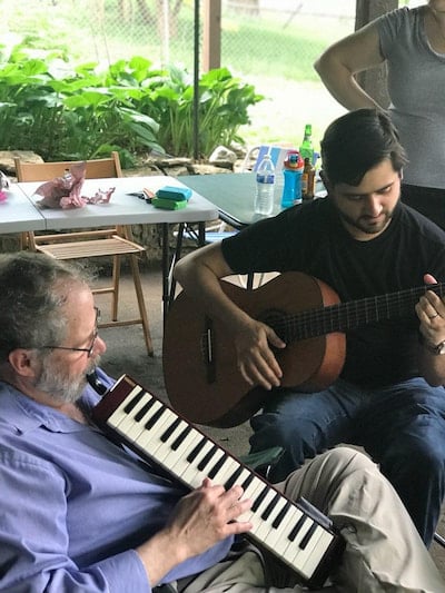 Two members of the the Children's Mercy Child Neurology Residency team play music together.