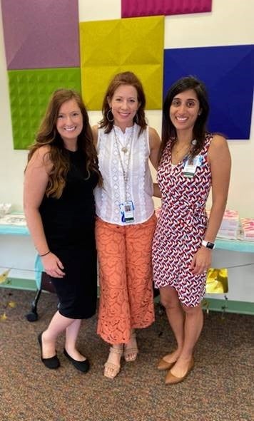 Three women stand together at the Pediatric Hematology Oncology Fellowship graduation.