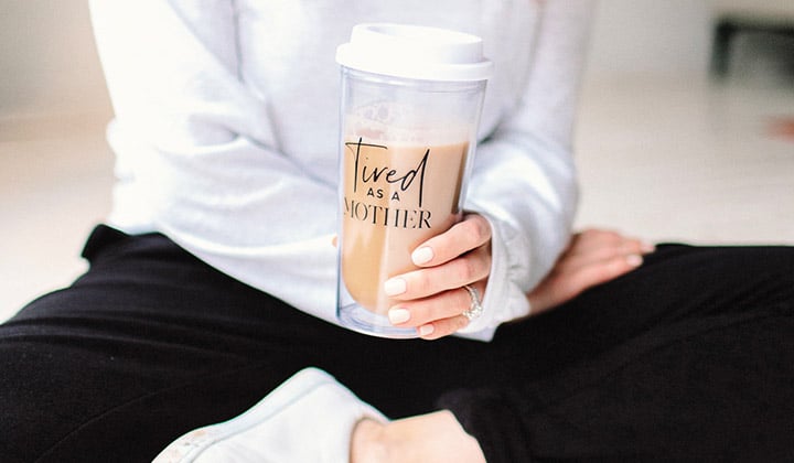 Woman holding a coffee mug tumbler