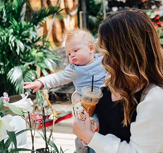 Mom holding baby who points