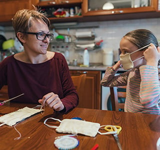 Mom and daughter crafting face masks