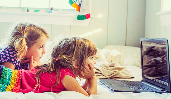 sisters watching tv on the laptop