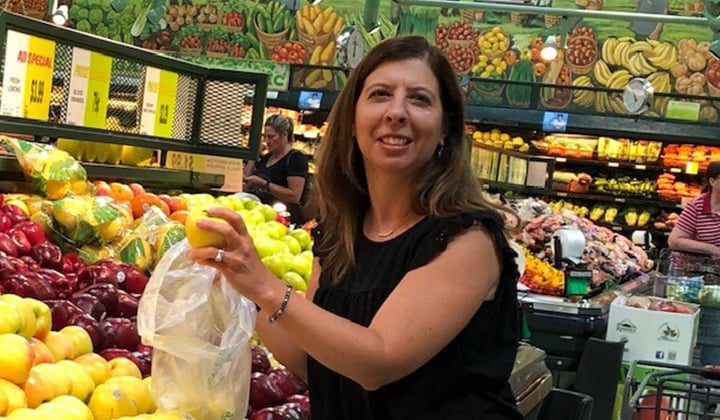 woman grocery shopping on a budget