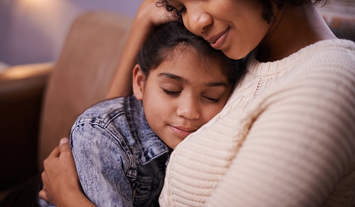 Mom hugging daughter