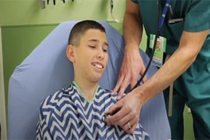Epilepsy patient, Derek, having his heart check by a physician