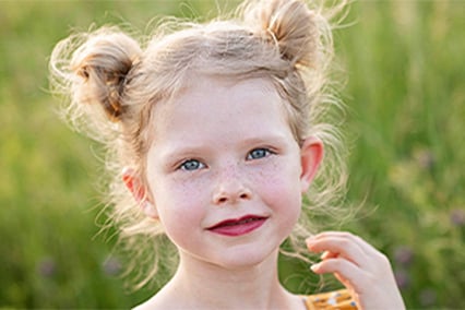 Quinn Liberman smiling with grassy field behind her