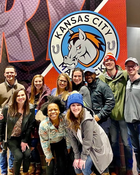 Children's Mercy Pediatric Residents pose together in front of the Kansas City Mavericks logo.