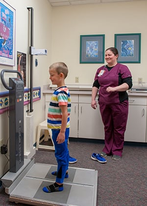 The nurse weighs a child in the Kidney Center at Children's Mercy.