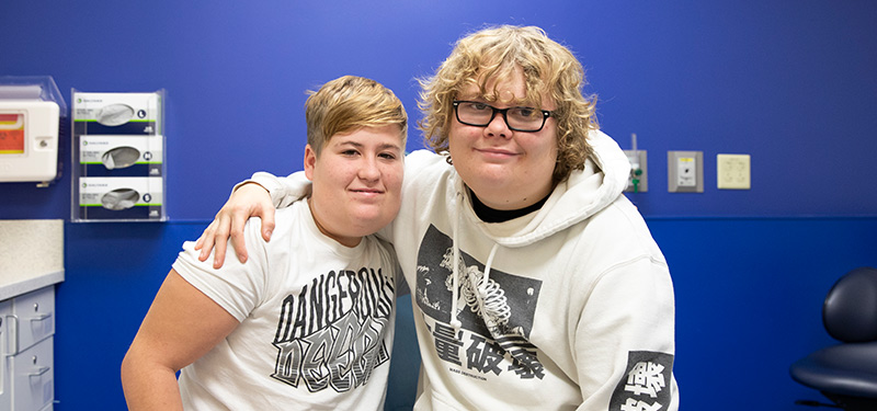 Two brothers with their arm around one another