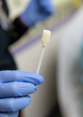 nurse cleaning port site with small sponge.